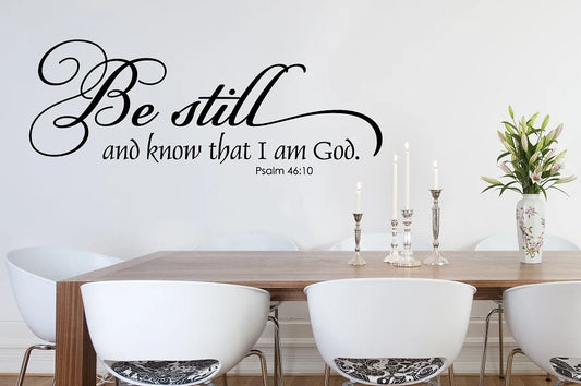 a dining room table with chairs and a wall decal