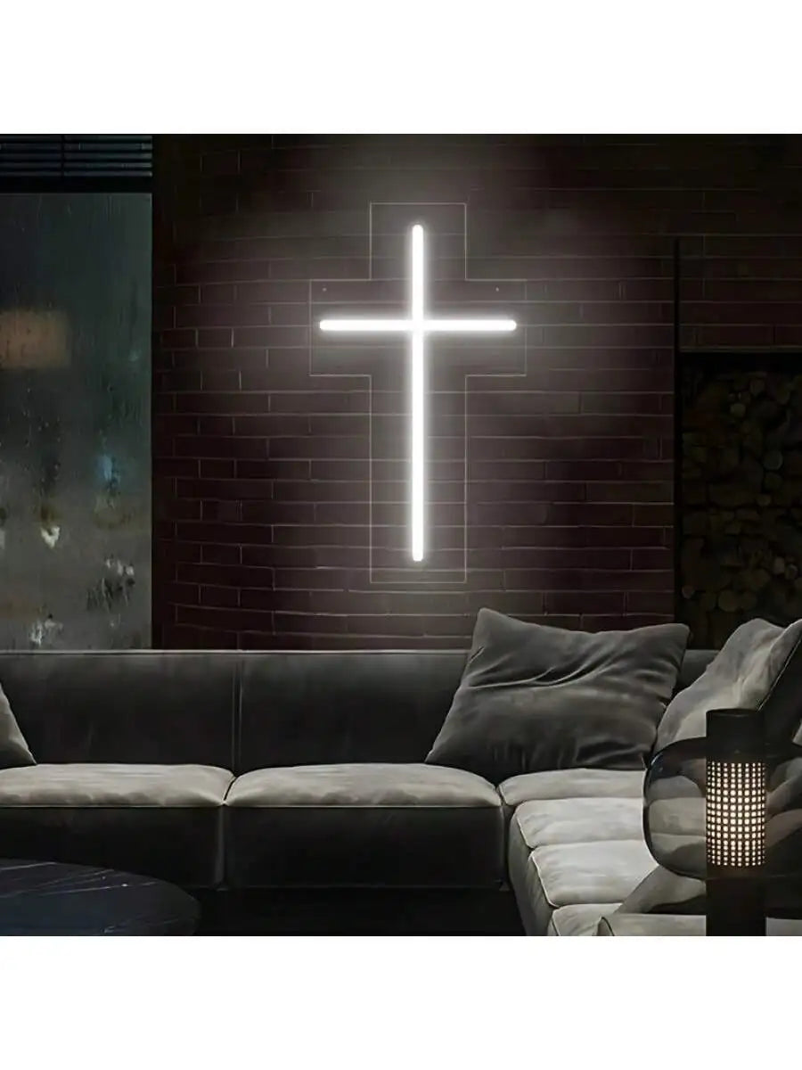 a living room with a couch and a cross on the wall